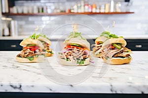 gyros sandwiches in a row on a counter with garnishes