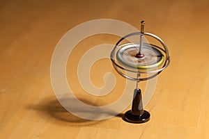 Gyroscope spinning and balancing on a wooden table