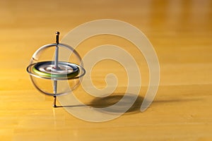 Gyroscope spinning and balancing on a wooden table