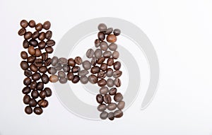 H is a capital letter of the English alphabet made up of natural roasted coffee beans that lie on a white background.