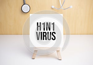 h1n1 virus sign on small wood board rest on the easel with medical stethoscope