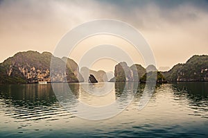 Ha long bay on a foggy day with dramatic rock scenery. Vietnam