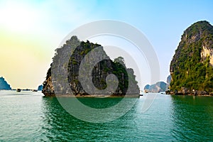 Ha Long Bay, Vietnam. Rock formations and boats at sunset in the South China Sea, Vietnam