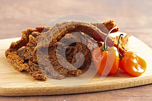 Habanero Pepper Flavored Gourmet Beef Jerky on a Wooden Cutting Board