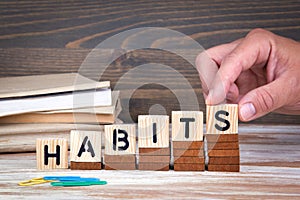Habits concept. Wooden letters on the office desk, informative and communication background photo