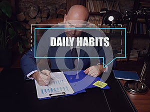 DAILY HABITS Individual Retirement Accounts text in block of quotes. Businessman doing paperwork A routine is the usual series of