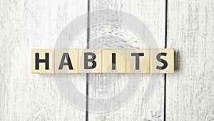 HABITS word written on wood block. HABITS text on cement table for your design, concept