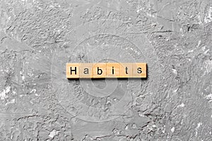 HABITS word written on wood block. HABITS text on cement table for your desing, concept