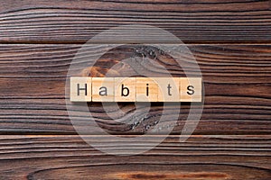 HABITS word written on wood block. HABITS text on cement table for your desing, concept