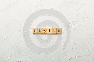 HABITS word written on wood block. HABITS text on cement table for your desing, concept