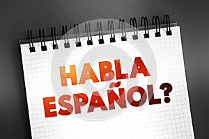 Habla Espanol? text quote on notepad, concept background