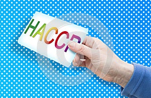 HACCP Hazard Analyses and Critical Control Points - Food Safety and Quality Control in food industry concept with text and hand