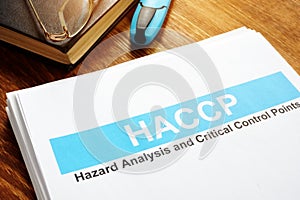 HACCP Hazard Analysis and Critical Control Points report on table