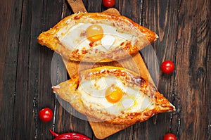 Hachapuri on Adjara. Beautiful open pies khachapuri with egg wood