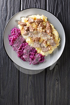 Hachee is a traditional beef and onion stew found in virtually every Dutch home.  closeup in the plate. vertical top view