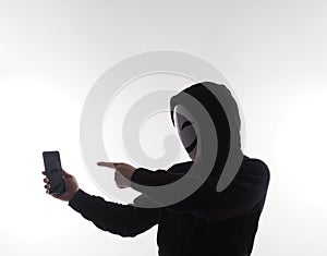 Hacker Anonymous and face mask with smartphone in hand