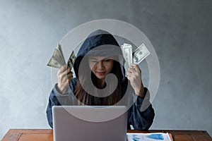 Hacker asia woman stealing data success by using laptop