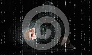 A hacker behind binary code, stream of data, able to break through cyber security and reaches his hand out to control your