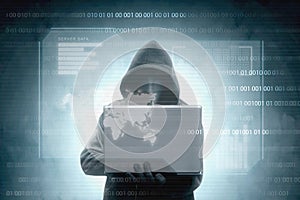 Hacker in black hoodie holding laptop with virtual display server data, chart bar, binary code and world map