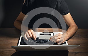 Hacker with credit card and laptop computer. Cyber crime