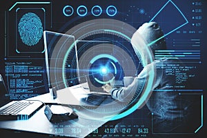Hacker at desktop using computer with digital business interface