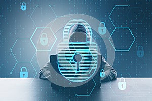 Hacker at desktop using laptop with glowing hexagonal padlock hologram with binary coding on blurry background. Safety, hacking,
