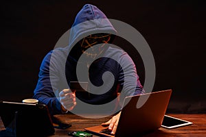 Hacker finding and exploiting the weakness in computer systems to gain access.