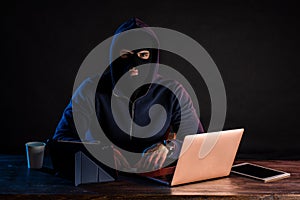 Hacker finding and exploiting the weakness in computer systems to gain access.