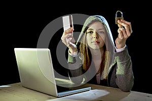 Hacker girl holding credit card violating privacy holding credit card in cybercrime and cyber crime