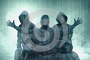 Hacker groups in black hoodie standing with binary code on virtual screen