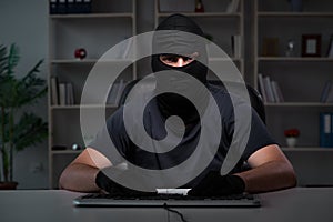 The hacker hacking computer late at night