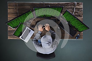 Hacker Hacking Multiple Computers On Desk