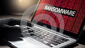 Hacker hand on laptop with ransomware attack screen