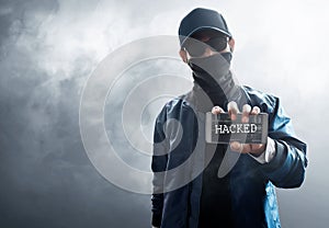 Hacker use mobile phone on smoke background
