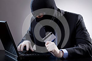 Hacker holding a credit card