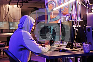 Hacker in hood breaking into server