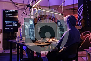 Hacker in hood using spyware