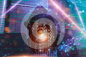 Hacker in hoodie attack laptop computer,dangerous data server and Infects system, binary code digital,hacking and malware