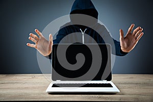 Hacker with laptop. Computer crime