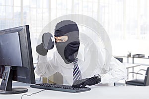 Hacker looking for information in office