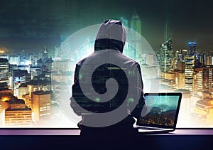 Hacker man with anonymous mask using laptop to hacking in the top building AI Generative photo