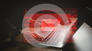 Hacker or programmer using laptop with triangle caution warning sign, coding, cryptography, hacker, crime, virus, for notification