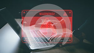 Hacker or programmer using laptop with triangle caution warning sign, coding, cryptography, hacker, crime, virus, for notification