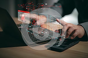 Hacker or programmer using laptop with triangle caution warning sign, coding, cryptography, hacker, crime, virus, for notification