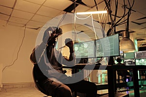 Hacker programming virus in vr helmet, hacking computer system