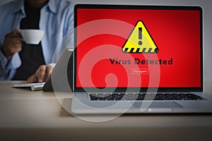 Hacker Protection Concept Man working on laptop Virus Detected A photo