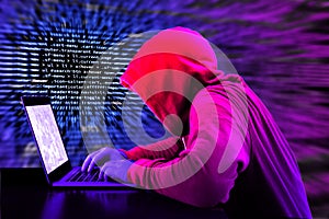 Hacker in a purple hoody in front of a blue code background with binary streams and information security terms cybersecurity