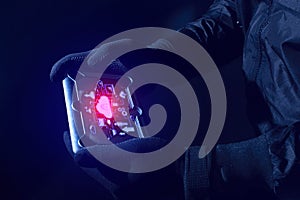 hacker robbery terrorist with tablet smartphone computer attack