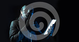 Hacker robbery terrorist with tablet smartphone computer attack