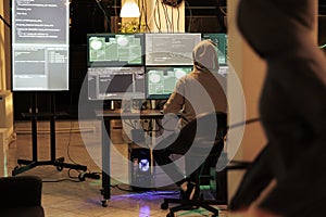 Hacker running malicious software code on computer, hacking database